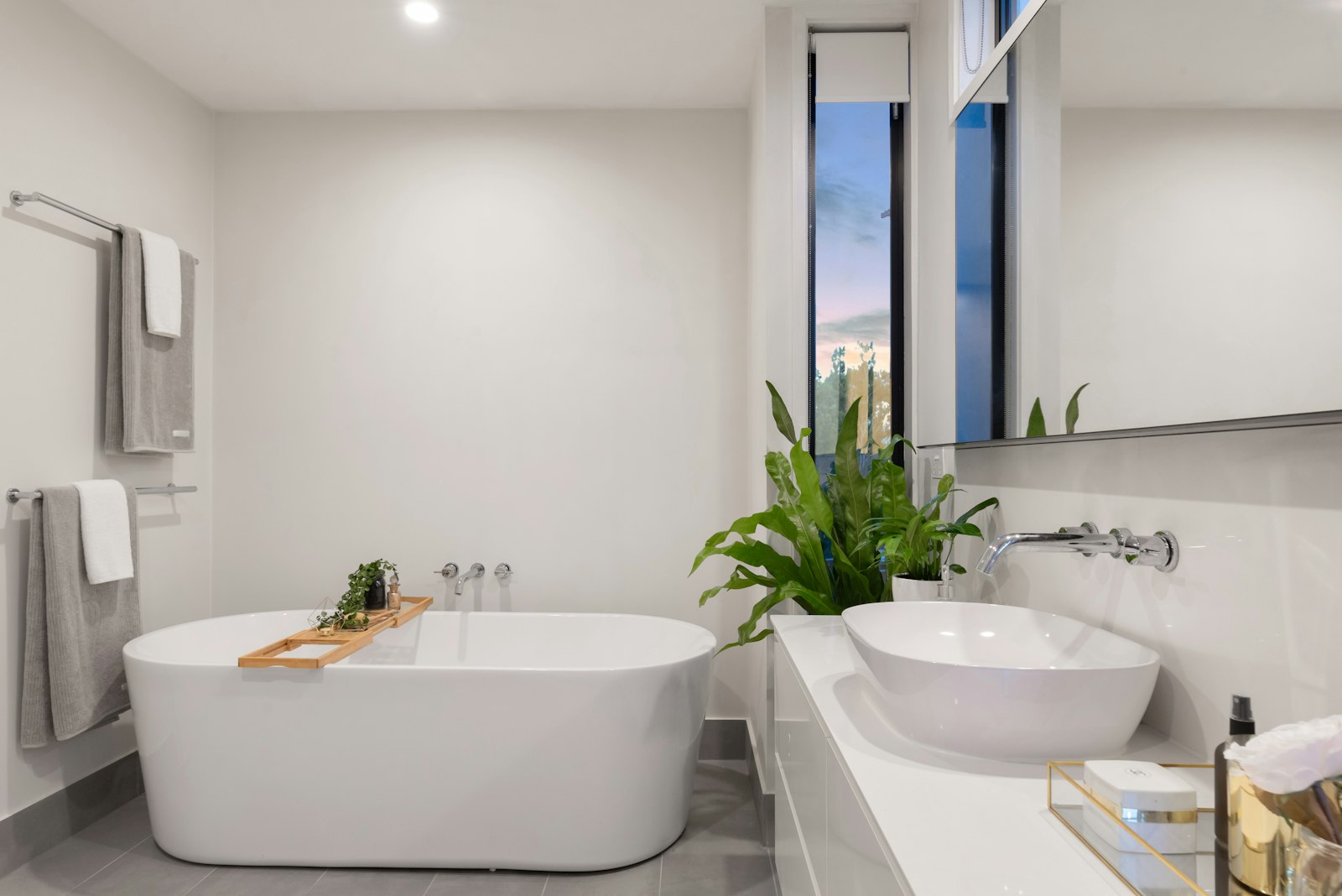 Calm bathroom with a freestanding tub, soft tile, and natural light