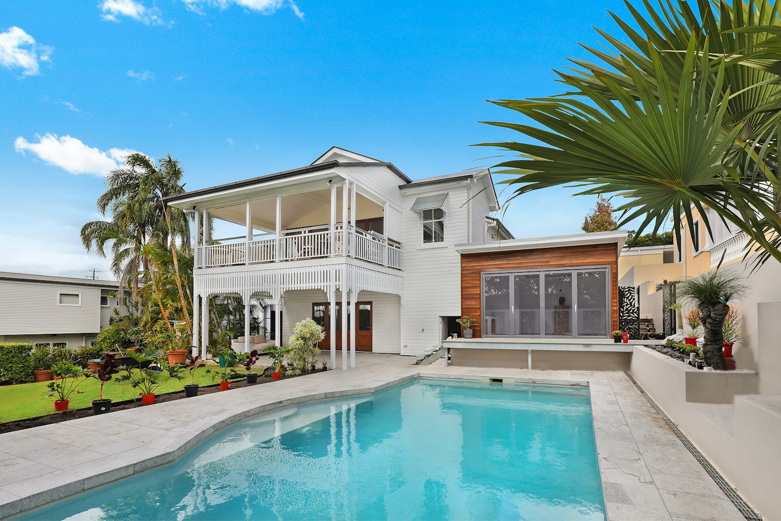 Refreshed house exterior with a simple white facade and broad windows